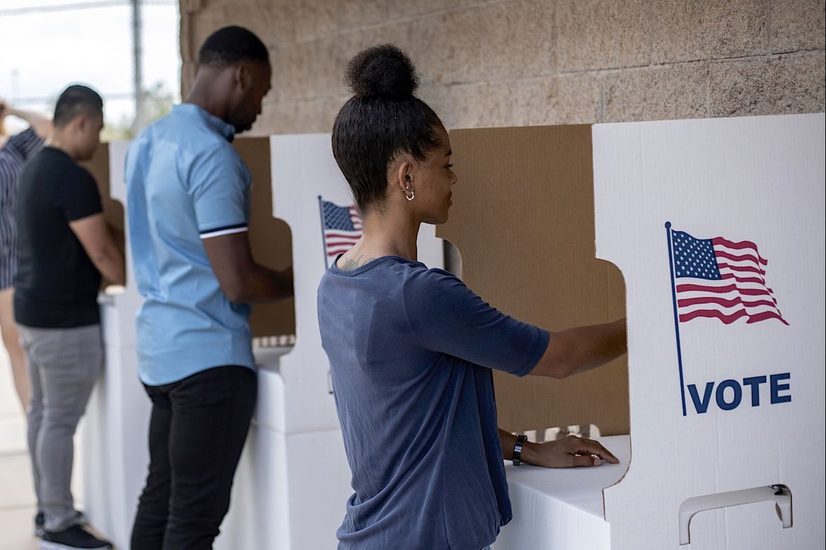 People voting at booths