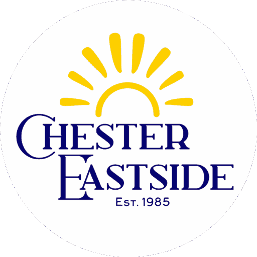 Chester Eastside logo. It is a yellow sun with the blue words Chester Eastside est 1985