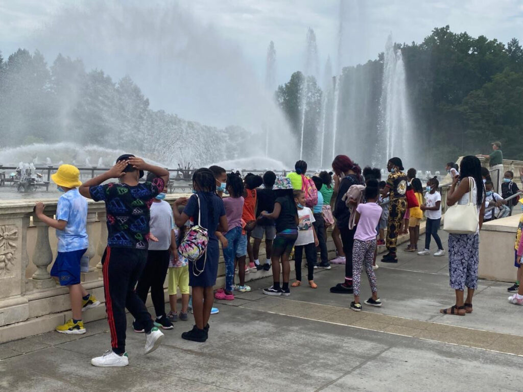 Large group of children watching a water fountain show