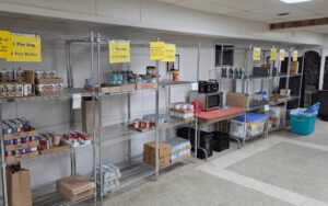 Metal shelves partially filled with cans of food