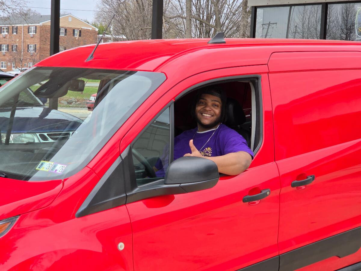 man driving red van